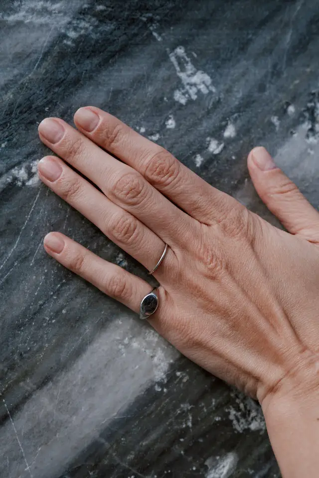 woman hand on marble floor