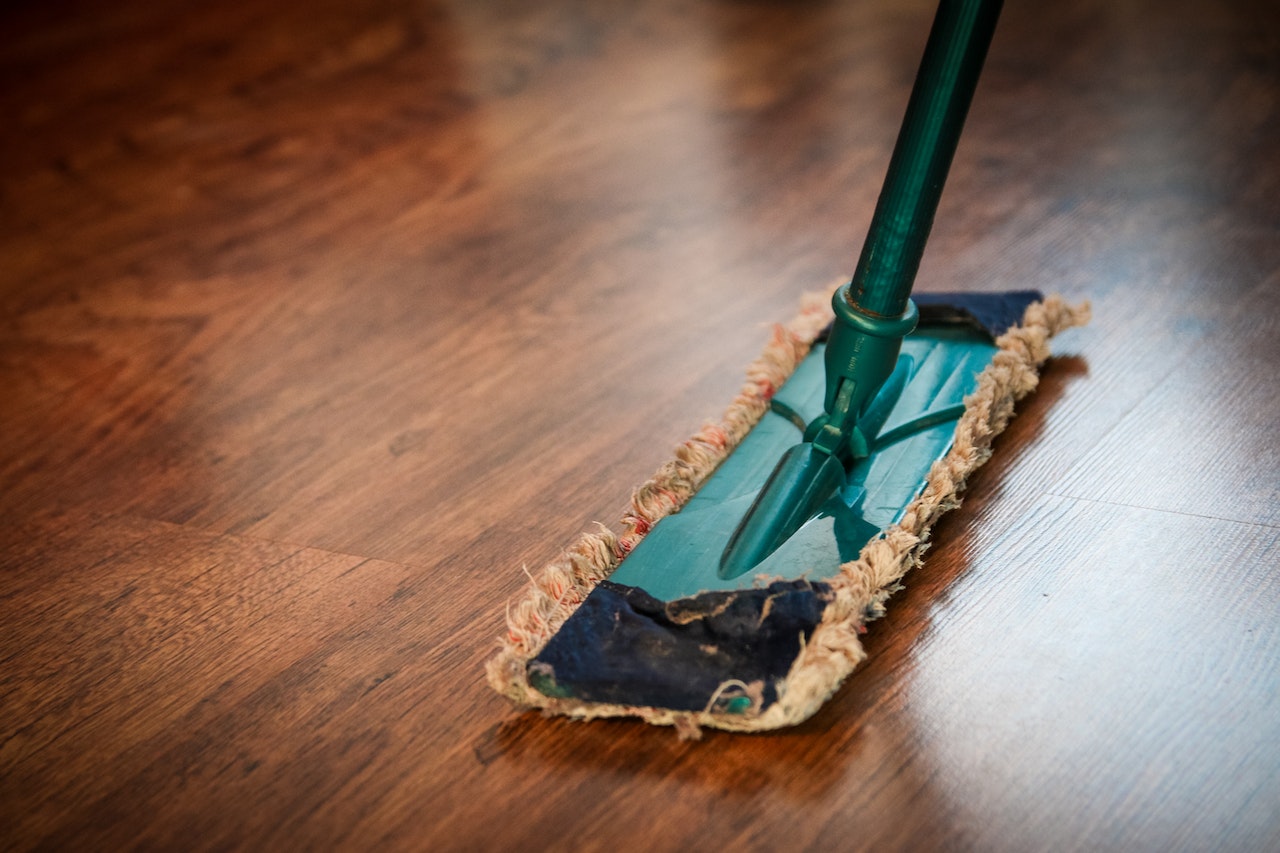 cleaning hardwood plank floor with dry mop